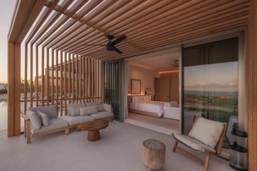 a living room with a couch and a bedroom at Park Hyatt Cabo Del Sol in Cabo San Lucas