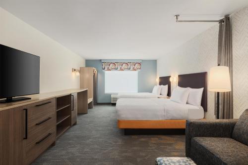 a hotel room with two beds and a flat screen tv at Home2 Suites By Hilton Springfield in Springfield