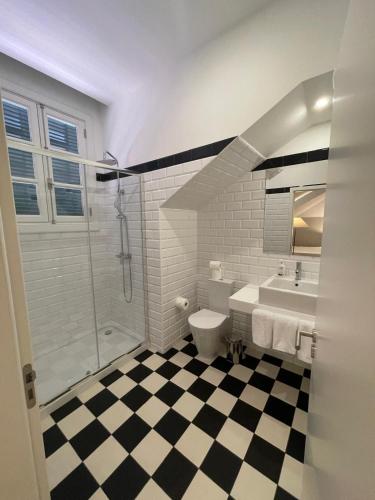 a bathroom with a shower and a toilet and a sink at PIER HOUSE Accommodation in Funchal