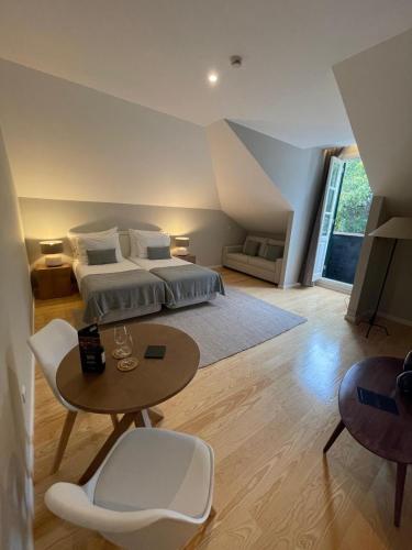 a bedroom with a bed and a table in a room at PIER HOUSE Accommodation in Funchal