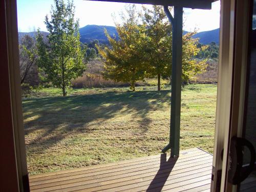 an open door of a porch with a view of a field at Colonial Inn Guest Rooms in Yackandandah