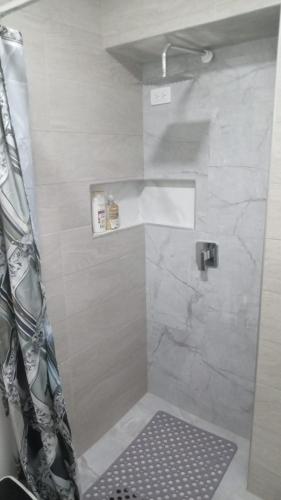 a shower with a shower curtain in a bathroom at SandritaHouse in Tuluá