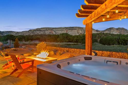 a hot tub on a patio with a view at ABODE at East Zion in The Fields in Orderville