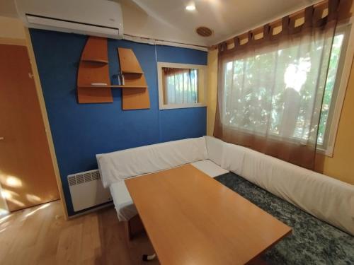 a living room with a couch and a table at Falaguera Bungalow 5 in Bárig