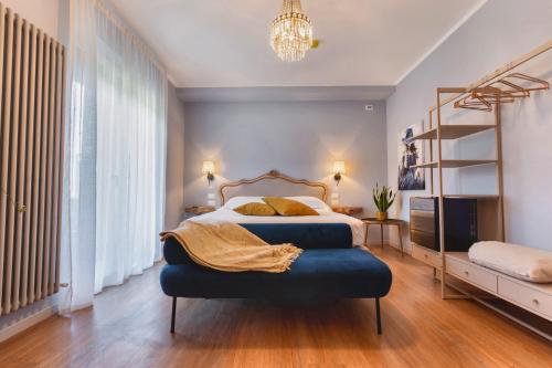 a bedroom with a bed with a blue ottoman at My Tuscany Turquoise Suite in San Quirico dʼOrcia