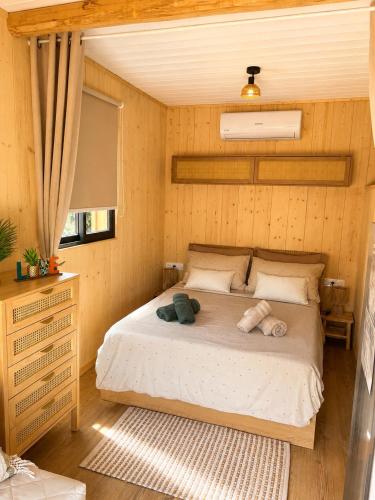 a bedroom with a bed with two stuffed animals on it at Isabella in Figari