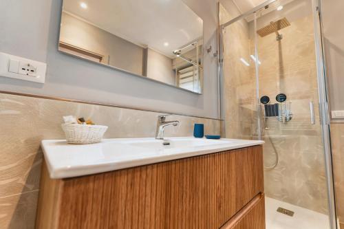 a bathroom with a sink and a shower at My Tuscany Turquoise Suite in San Quirico dʼOrcia