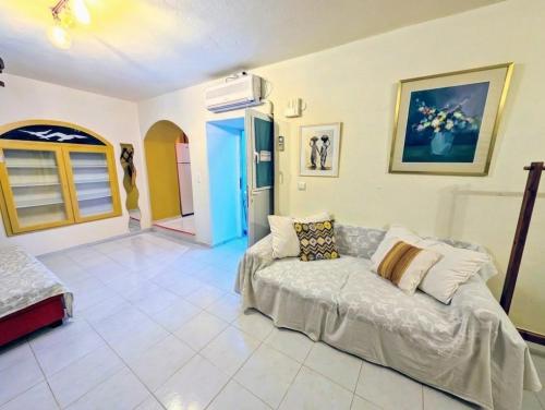 a living room with a couch in a room at Ύδρα ivY in Hydra
