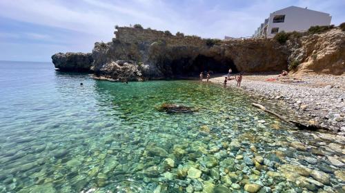 a beach with clear water and a rocky shore at Vientos de Tabarca 5 in Tabarca