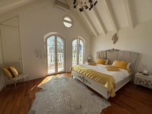 a bedroom with a bed and a large window at Villa Löwe - Heated Indoor Pool, Spa & Wellness Estate near Basel in Kandern