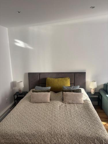a bedroom with a large bed with two pillows at Apartment Ela Centre in Košice