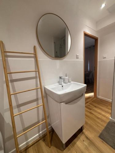 a bathroom with a sink and a mirror on the wall at Apartment Ela Centre in Košice