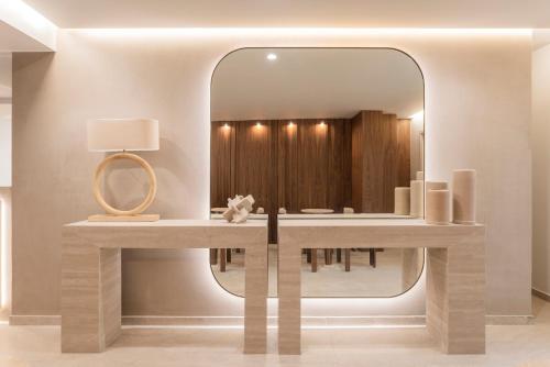 a dressing table with a mirror in a room at Anthem Suites & Spa in Athens