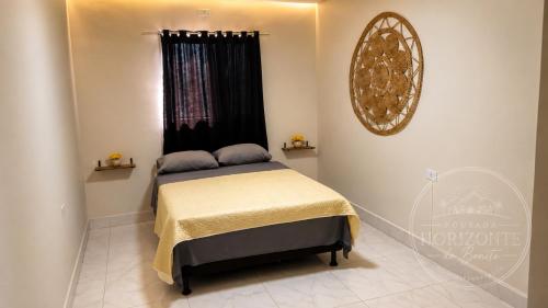 a small bedroom with a bed with a window at Pousada Horizontes de Bonito in Bonito
