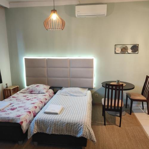 a bedroom with a bed and a table and chairs at Redkot 40A in Zielona Góra