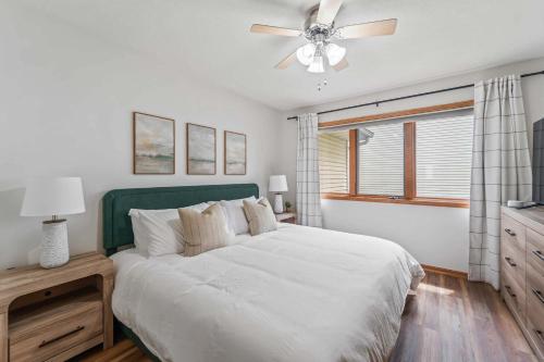 a bedroom with a white bed and a ceiling fan at Des Moines 4BR Family Getaway in Des Moines