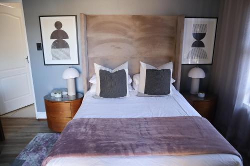 a bedroom with a large bed with two night stands at Blue Crane Luxury Accommodation in Welkom