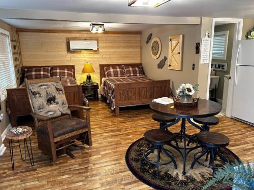 a living room with a bed and a table at Old No. 8 Cabin in Alpine