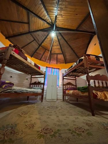 two bunk beds in a room with a roof at Comarca del Hobit in Yala