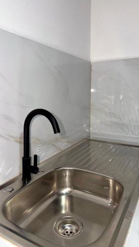 a kitchen sink with a black faucet at Casa Colibrí #1 in Puerto Jiménez
