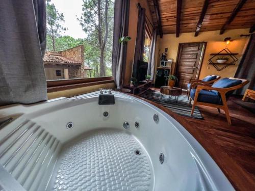 a large white bath tub in a room at Cabañas VIP in Mazamitla