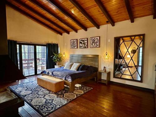 a bedroom with a bed and a large window at Cabañas VIP in Mazamitla