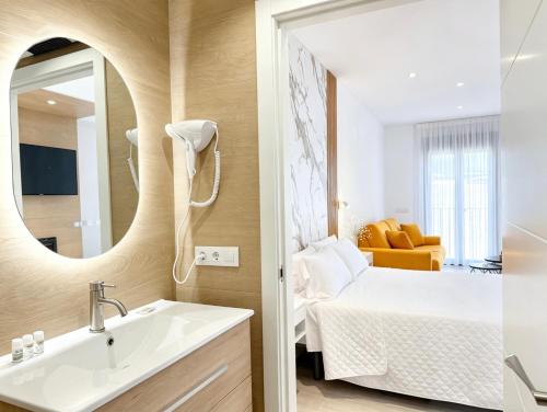 a bathroom with a sink and a mirror at La Serrería-Premium Suite Apartments & Private Jacuzzi in Belmonte
