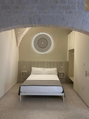 a bedroom with a bed and a ceiling at Dimora Noci Mia in Noci