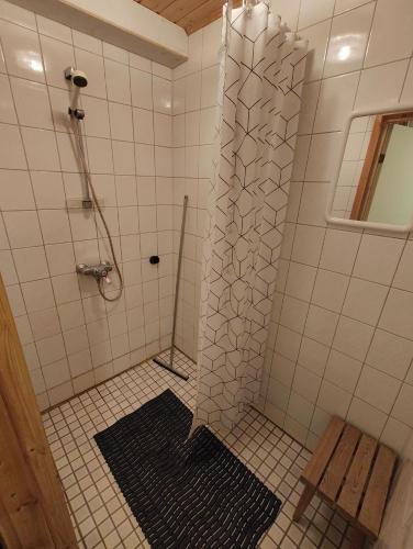 a shower with a glass door in a bathroom at Wanha Mannila in Savonlinna