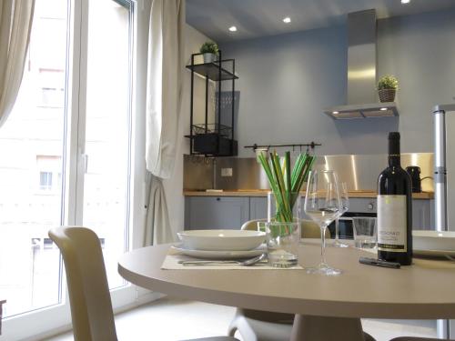 a table with a bottle of wine and a glass at 8 Colonne Apartments in Bologna