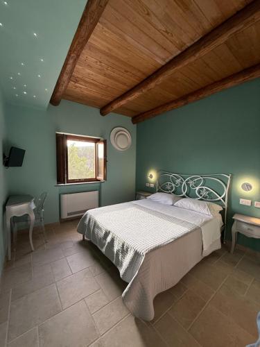 a bedroom with a large bed with a wooden ceiling at Domus Lauri in Laurino