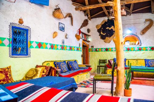 a living room with colorful furniture in a room at Traditional Berber Eco Farm Stay in Agadir