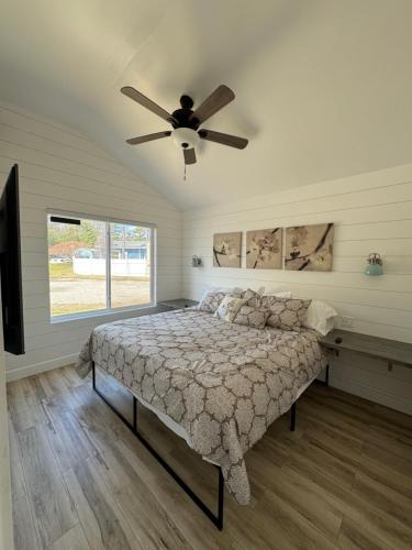 a bedroom with a bed and a ceiling fan at SANDY BEACH Paradise On The Beach in Lincoln Junction
