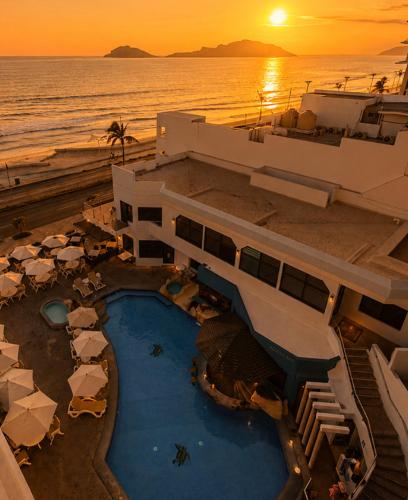 an aerial view of a resort with a pool and the ocean at Olas Altas Inn Hotel & Spa in Mazatlán