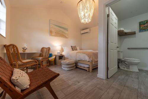a bedroom with a bed and a bathroom at Seahorse Beach Bungalows in Fort Pierce
