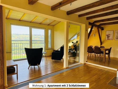 a living room with a table and chairs at Schads Bergheimat in Wertach