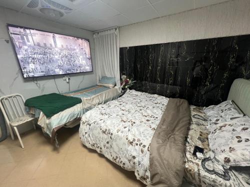 a bedroom with two beds and a large window at Sahara View Guest House Prime Location on the Dubai Sharjah Border in Sharjah