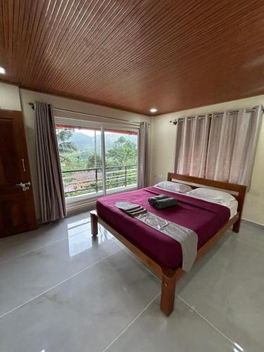 a bedroom with a large bed and a large window at Spatika Villa in Madikeri