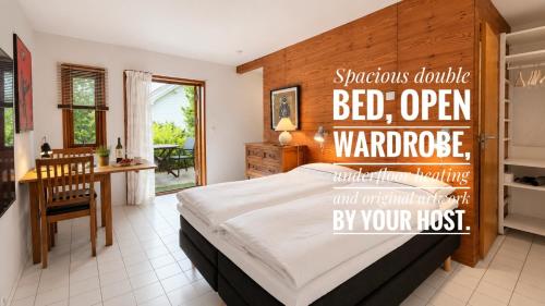 a bedroom with a bed with a wooden headboard at Bergvegen Guesthouse Aalesund in Ålesund