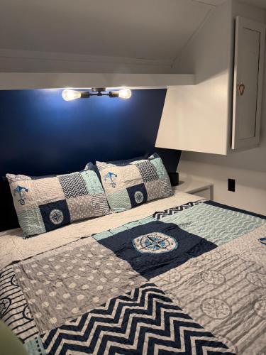 a bedroom with a bed with pillows on it at Camper Rental in Saint Helena Island