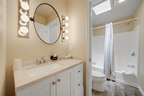 a bathroom with a sink and a toilet and a mirror at West Sonoma Inn & Spa in Guerneville