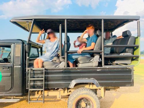 a group of people sitting in the back of a jeep at Galoya Red Lotus in Ampara