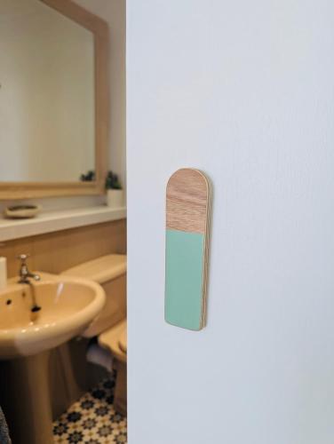 a refrigerator with a door with a mirror and a sink at Treheveras Guest House in Newquay