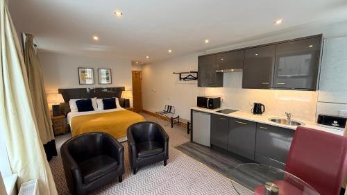 a hotel room with a bed and a bathroom at Crystal House in Barmouth