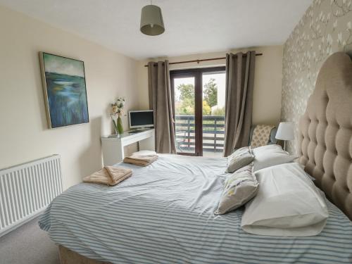a bedroom with a large bed with pillows on it at Ty Haf in Holyhead