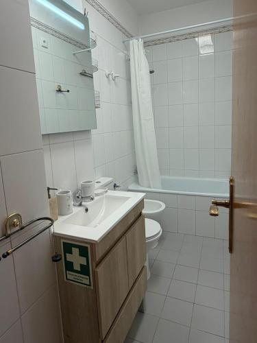 a white bathroom with a sink and a toilet at Atlantic Romantic Caparica Flat in Costa da Caparica