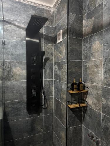 a bathroom with a shower with a glass door at Appart Hidaya in Fez