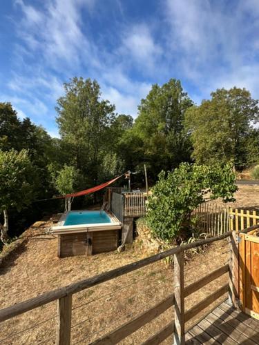 a playground with a swimming pool and a fence at Logis de Rault in Sainte-Ouenne