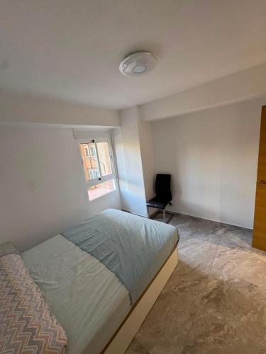 a bedroom with a bed and a window at Maristas in Valencia