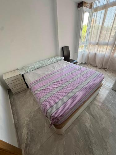 a large bed in a room with a window at Maristas in Valencia